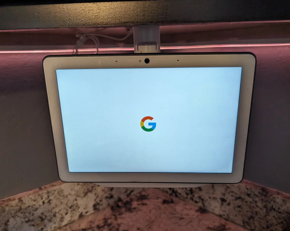 Google Nest Hub installed in an under-cabinet swivel mount